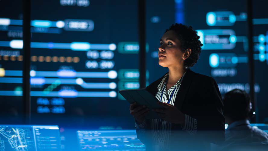 Analyst reviewing data in a digital control room